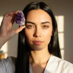 Crystals that help with focus: A woman holding an amethyst